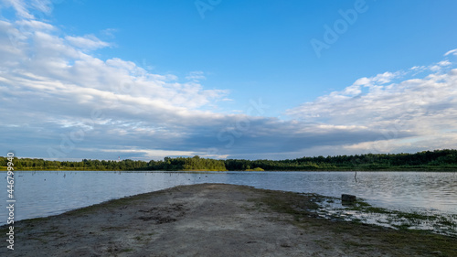 Fototapeta Naklejka Na Ścianę i Meble -  Aerial view of a beautiful and dramatic sunset over a forest lake reflected in the water, landscape drone shot. Blakheide, Beerse, Belgium. High quality photo