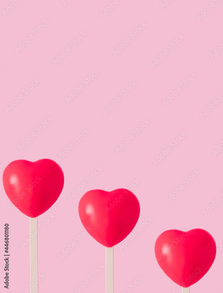 Creative pattern with red hearts with ice cream stick on pastel pink background. Love romantic concept.