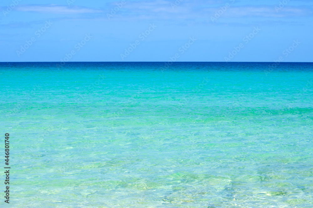 View of the horizon and transparent, sparkling blue ocean water in different shades. Atlantic ocean, Canary islands.