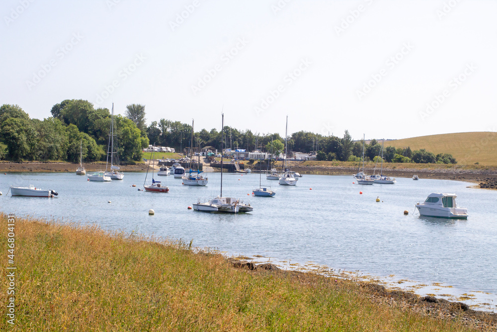Pleasure boats moored in the calm waters at the National Trust property at Gibbs Island