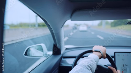 Wallpaper Mural Businessman in luxury clothes and with high cost watch driving a car with fastened seat belt, back view of responsible man following all the traffic rules while driving across the highway. Rear view Torontodigital.ca