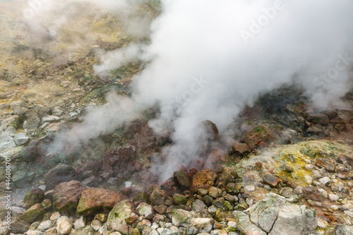 Exciting view of volcanic landscape, erupting fumarole, aggressive hot spring, gas-steam activity in crater of active volcano. Beautiful mountain landscape, travel destinations for active vacation.