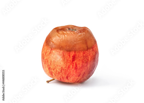 Half rotten apple. Red apple with brown decomposed, soft and squishy spoiled section. Concept for food waste and food safety or bad apple. Isolated on white. photo
