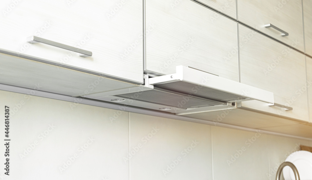 Power on cooker hood in modern kitchen interior, kitchen applicance concept background photo Power on cooker hood in modern kitchen interior, kitchen applicance concept background photo