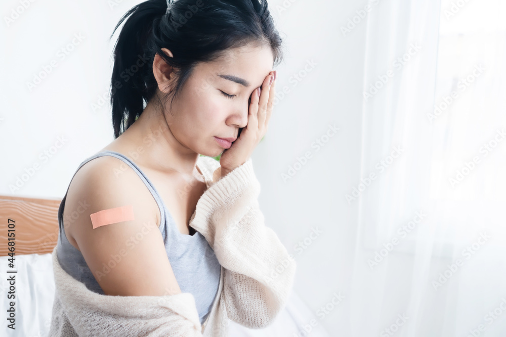 Asian woman having headache, fever, dizzy and allergy side effects after receiving vaccination for covid-19 Asian woman having headache, fever, dizzy and allergy side effects after receiving vaccination for covid-19