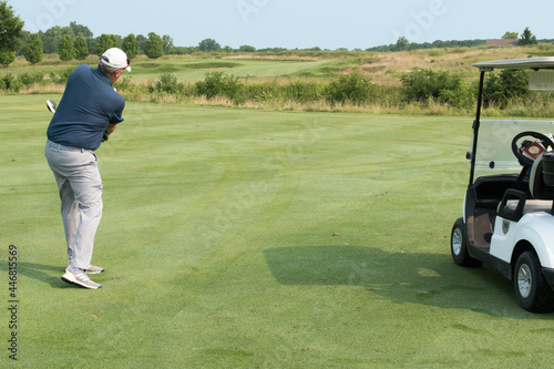 A Golfer makes his approach shot on a links course.