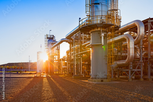 View of a gas refinery plant illuminated at sunset photo