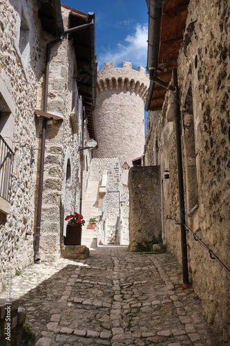 flowery alley with a view of the tower in the medieval town of santo stefano di sessanio abruzzo photo