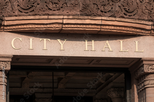 City Hall in gold text set against granite columns. photo