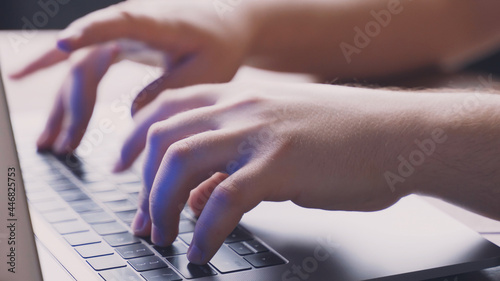 hands typing a program on a computer keyboard