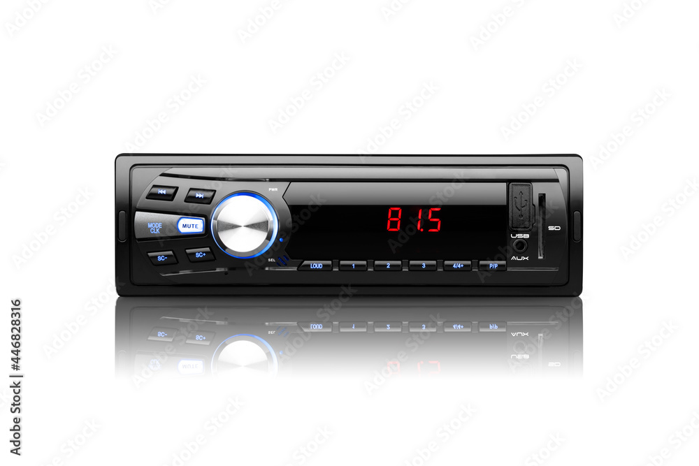 Front view of a black automobile radio with screen on with silver button on white background with reflection underneath