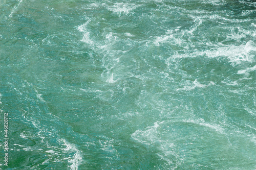 Close-up of clear blue river water. River flow