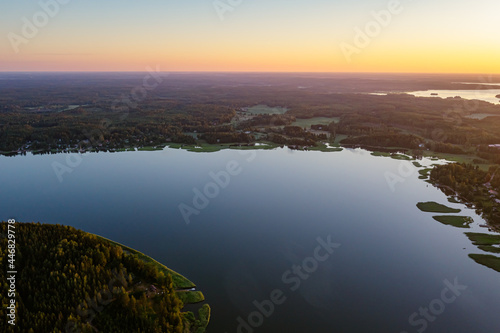 Forested islands in the sea at sunrise. Nature of Scandinavia  Finland. Photo from the drone.