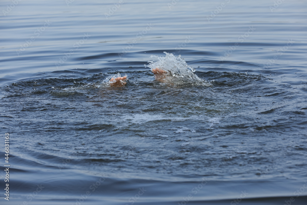 Fototapeta premium Drowning man reaching for help in sea, closeup