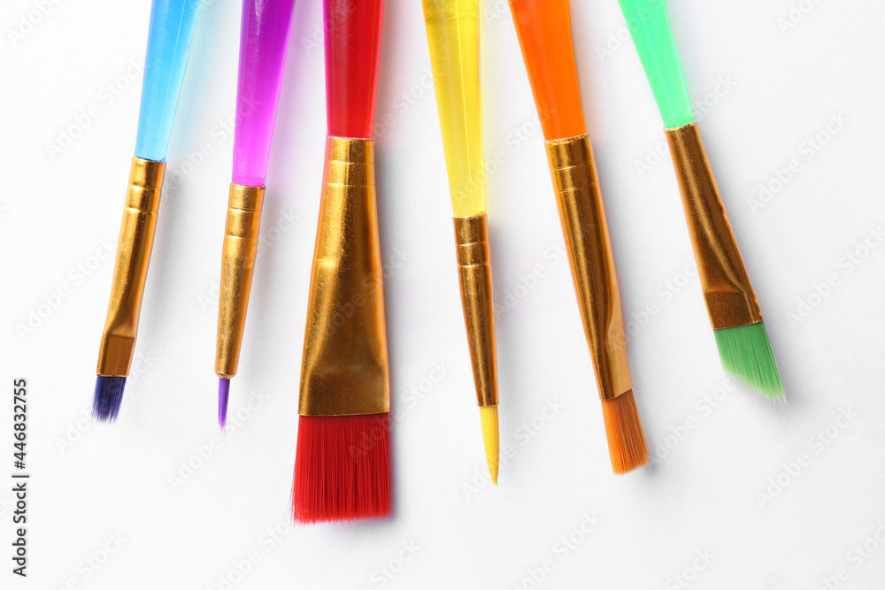 Fototapeta premium Set of different paintbrushes on white background, top view