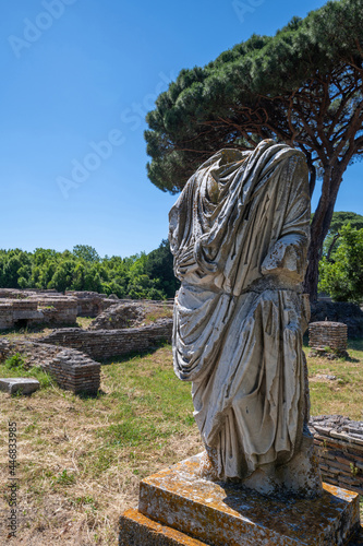 Rome, Ostia Antica, Italy. Ancient Roman ruins, detail of a Roman statue in marble togata Ostia Antica archaeological park. Roman port along the Tiber and the Tyrrhenian Sea.  photo