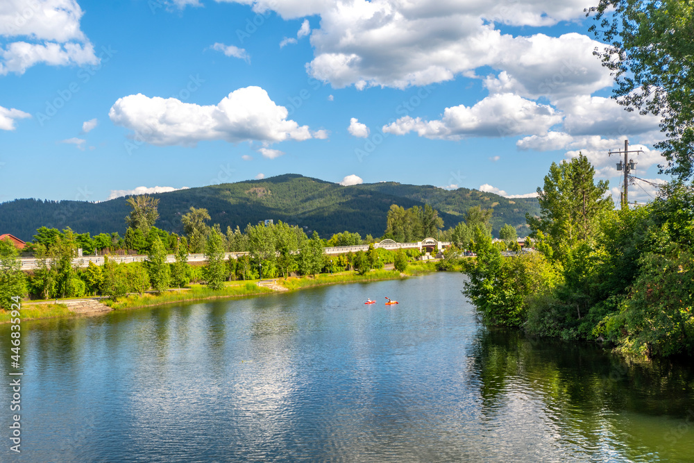 A group of kayakers enjoy a beautiful summer day on Sand Creek River and Lake Pend Oreille in the downtown area of Sandpoint, Idaho, USA