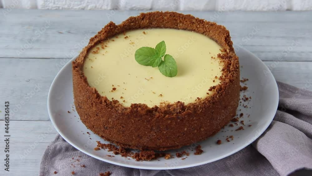 Cheesecake decorating with mint. Woman hands put mint on New York dessert. Close up	
