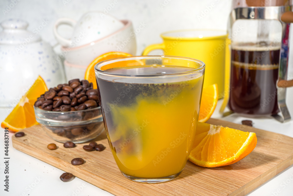 Bumble bee Coffee cocktail. Homemade hot drink with espresso and orange juice, on white kitchen table copy space Bumble bee Coffee cocktail. Homemade hot drink with espresso and orange juice, on white kitchen table copy space