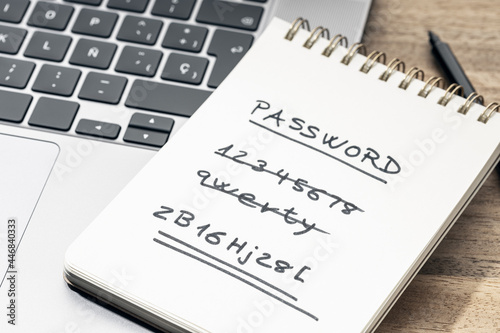 Strong and weak easy Password concept. Handwritten text on notepad on laptop photo