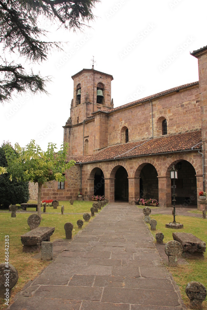 Fototapeta premium Etxalar Church with a central stone passage and a garden