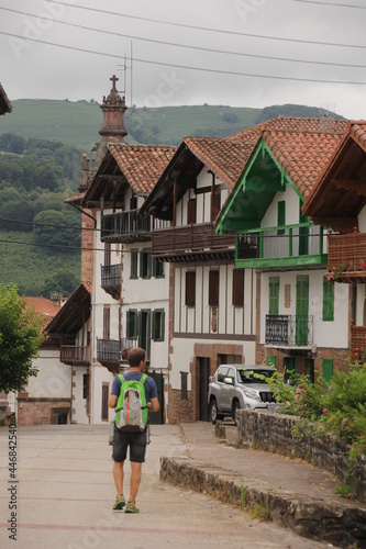 Typical Basque houses with a boy walking down the street in Arizcun, Navarra