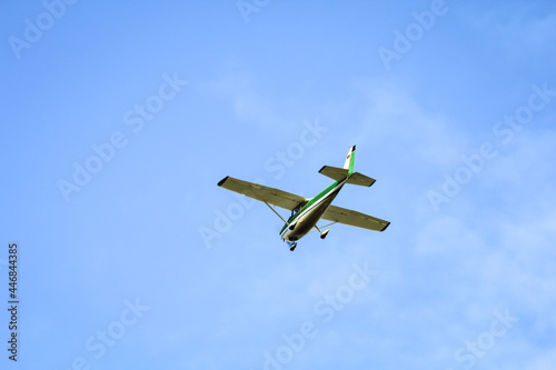 Ein grünes Kleinflugzeug nähert sich im Landeanflug.