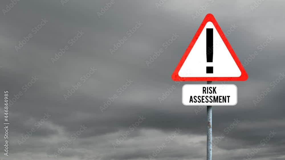 Attention signboard post with risk assessment text against dark clouds in the sky Attention signboard post with risk assessment text against dark clouds in the sky