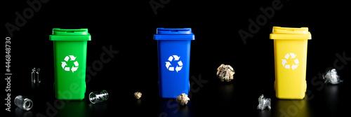 Recycling set bins. Yellow, green, blue dustbin for recycle plastic, paper and glass can trash isolated on black background. Container for disposal garbage waste and save environment.