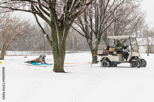 Dad and Kid having Fun in the Snow Golf Cart Pull Behind Sled 