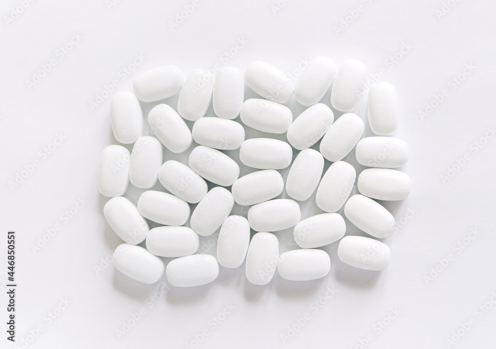 White pills on a White background. Healthcare and medicine.	
