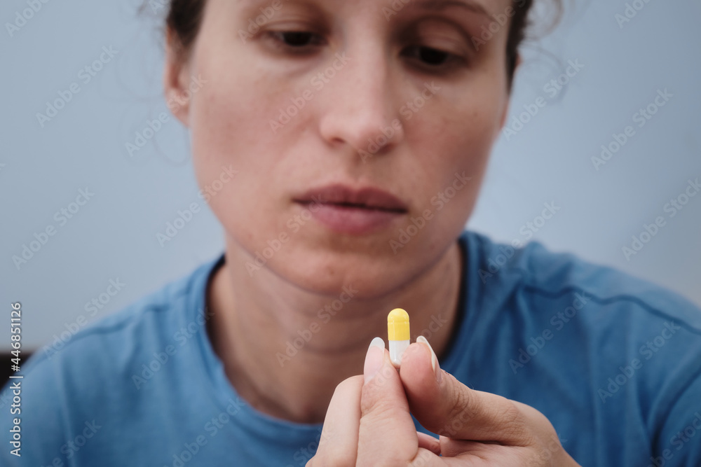 A woman takes a capsule of medicine. Consumption of the drug. Treatment of the disease A woman takes a capsule of medicine. Consumption of the drug. Treatment of the disease