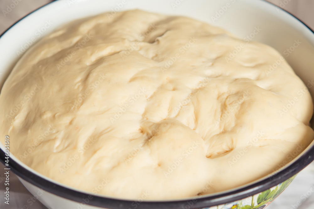 Process of raising the dough in a special basket. Dough made from natural sourdough. Wheat dough. Fermentation. Top view. Process of raising the dough in a special basket. Dough made from natural sourdough. Wheat dough. Fermentation. Top view.