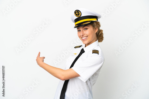 Airplane blonde woman pilot isolated on white background pointing back photo
