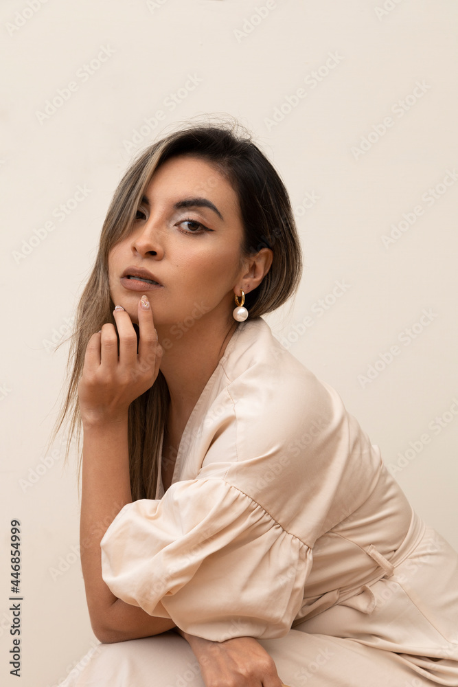 young woman with long straight hair is posing in a relaxed way, wearing makeup and a pink robe, lifestyle and beauty in studio young woman with long straight hair is posing in a relaxed way, wearing makeup and a pink robe, lifestyle and beauty in studio