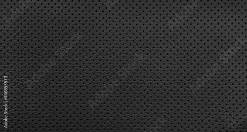 Closeup black leather of interior material for sport car. Modern, luxury and quality element for design decorative. Rough texture background. Pattern wallpaper.