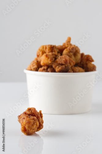 chicken pop corn , withe bucket bowl. white background 