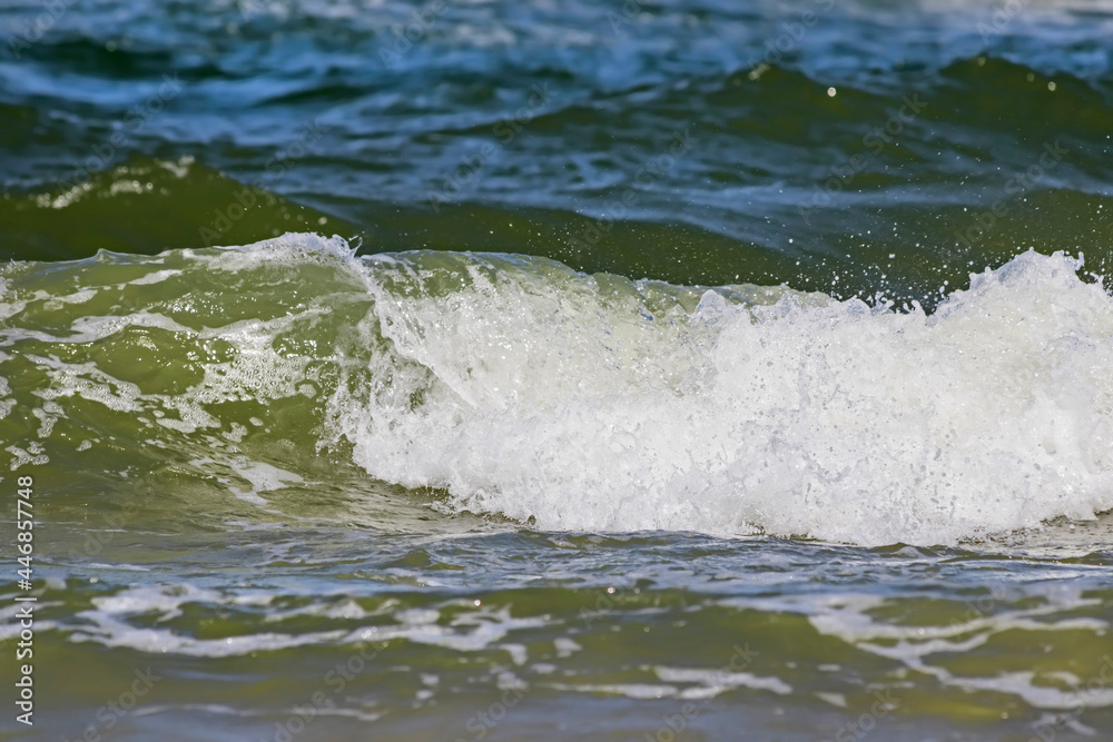 Landscapes of Poland. Breakwater at Baltic sea. Wavy water.