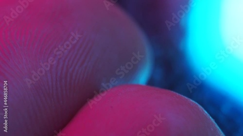 finger prints macro detail of skin. Pink blue light 4k close up detail.