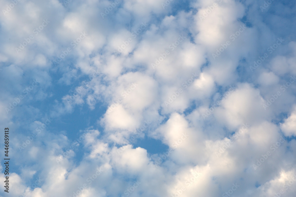 White cumulus clouds in a blue sky. Backgrounds with a pattern of high-beam clouds. Weather, seasonality, ecology, clear sky. White cumulus clouds in a blue sky. Backgrounds with a pattern of high-beam clouds. Weather, seasonality, ecology, clear sky.