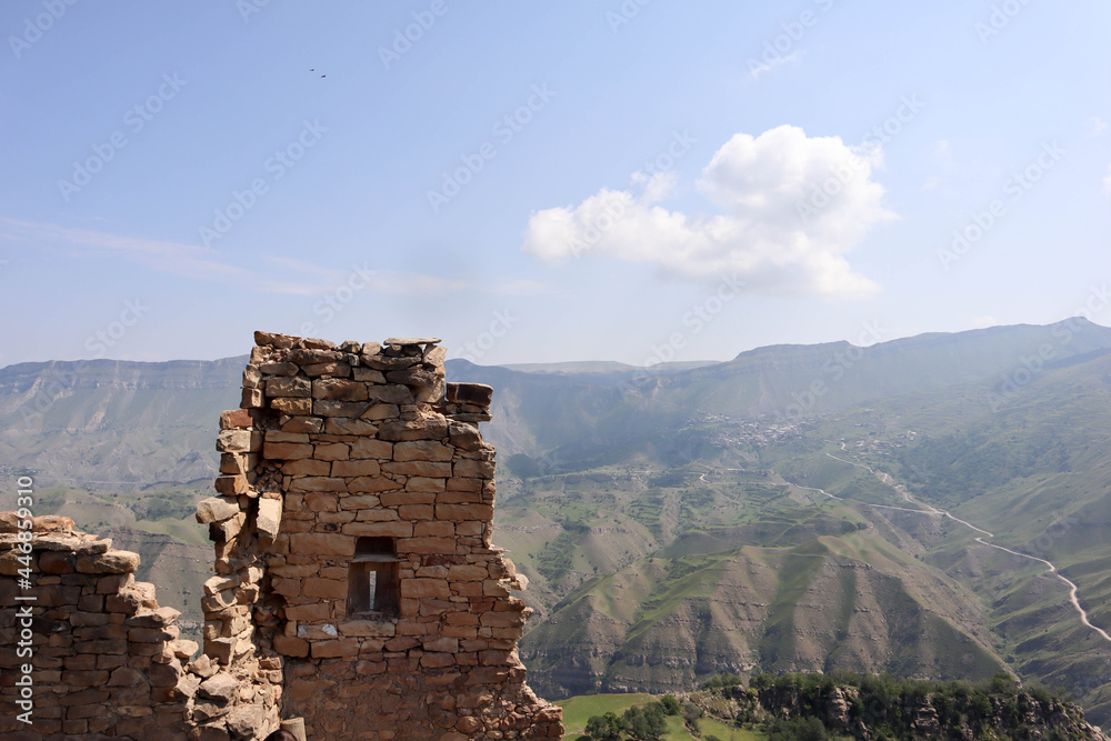 preserved wall with the window in ruined house of abandoned ancient village Gamsutl in the Dagestan, Russia
