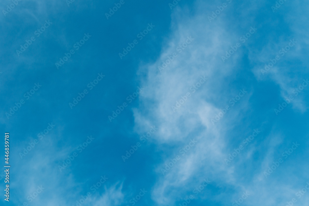summer blue sky with white cirrus clouds. Natural background for design, copy space.