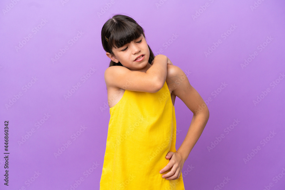 Little caucasian kid isolated on purple background suffering from pain in shoulder for having made an effort Little caucasian kid isolated on purple background suffering from pain in shoulder for having made an effort