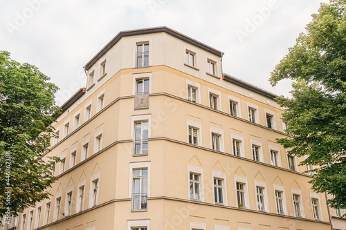 yellow apartment corner building at weissensee, berlin