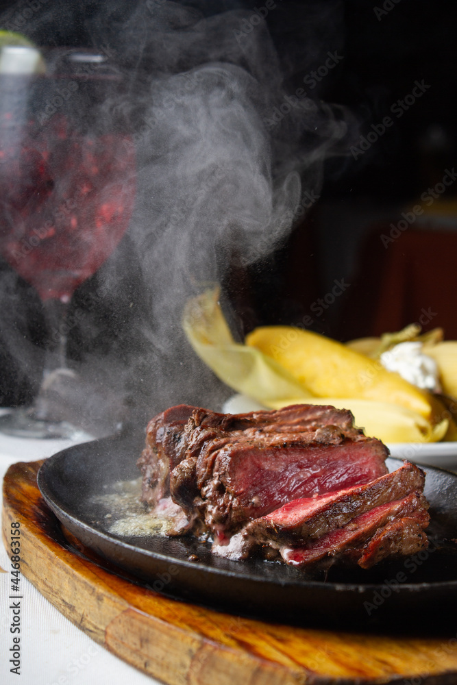 steamy beef on restaurant table with wine steamy beef on restaurant table with wine
