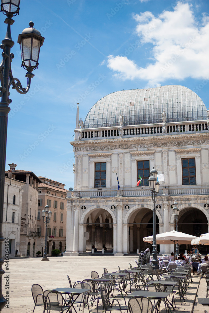 The Palazzo della Loggia is a renaissance square with a city hall (Comune di Brescia) surrounded by Venetian-style buildings located in the town in Lombardy, Italy. Historical European landmark.