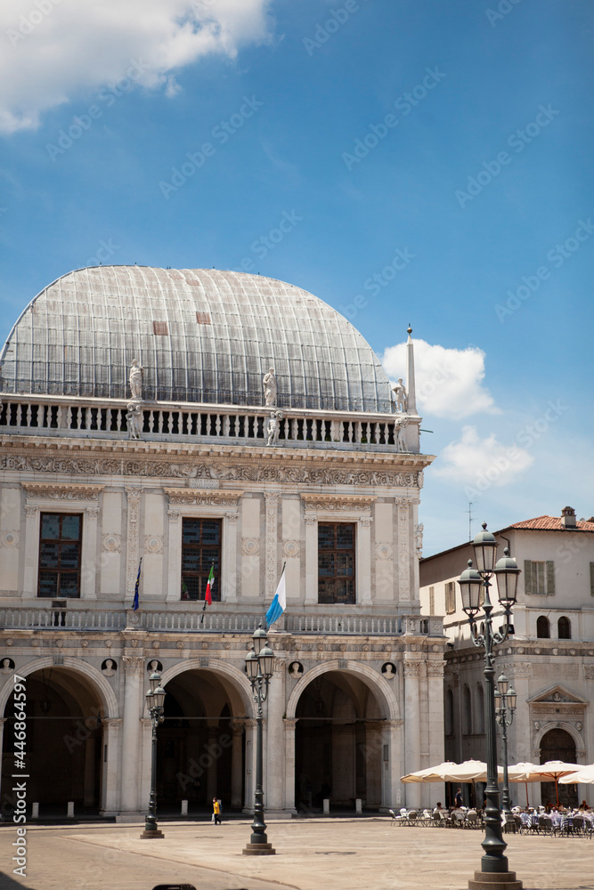 Naklejka premium The Palazzo della Loggia is a renaissance square with a city hall (Comune di Brescia) surrounded by Venetian-style buildings located in the town in Lombardy, Italy. Historical European landmark.