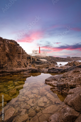 Amazing lighthouse in the Portuguese coastline at the sunset.
