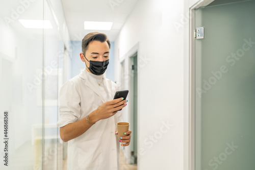 doctor consulting their smartphone on their break