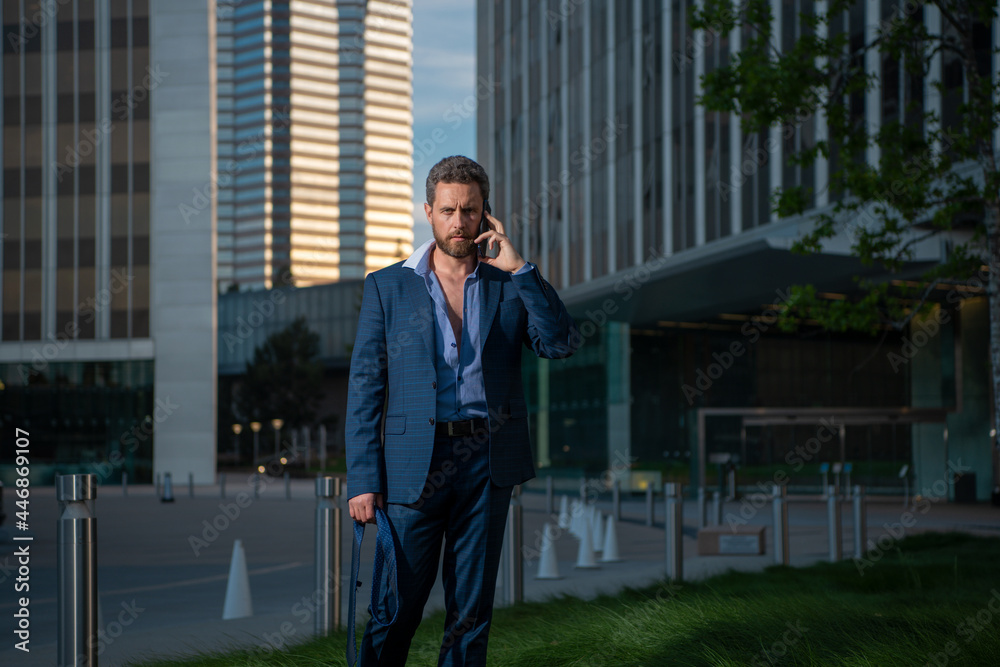 Businessman with phone stand up and night city background. Businessman with phone stand up and night city background.